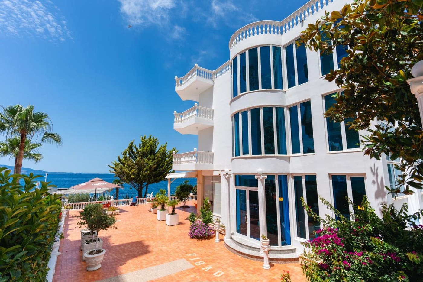 The white front of Hotel VISAD, above its terrace and the sea
