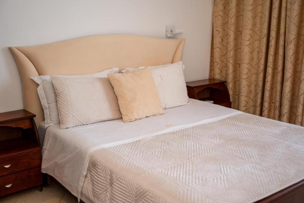 A double bed, made up in white